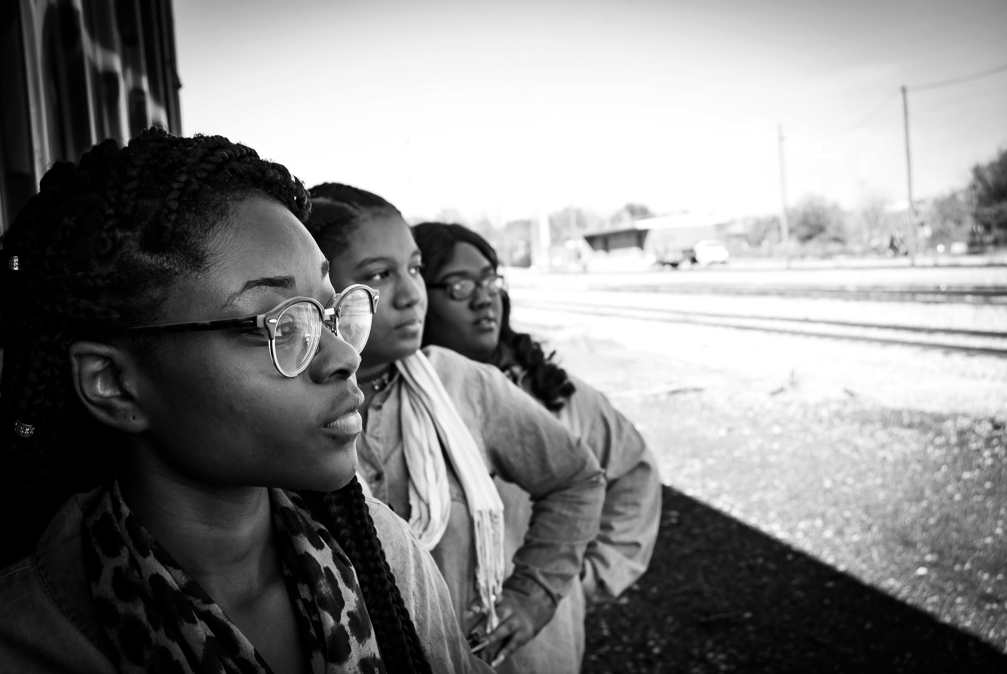 Three young Black girls looking to the distance
